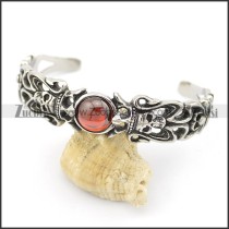 steel skull bangle with round clear red stone b002494