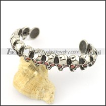 16 small skull heads bangle with clear red zircons b002305
