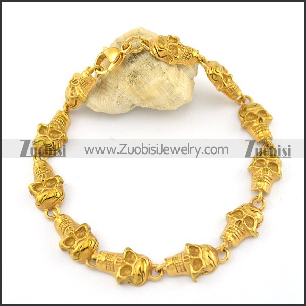 11 small skull heads bracelet in gold tone b002342